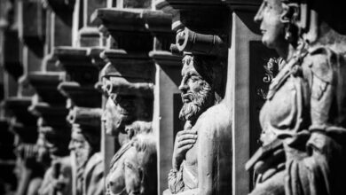 History - Black and white photo of historic stone sculptures showcasing intricate craftsmanship.