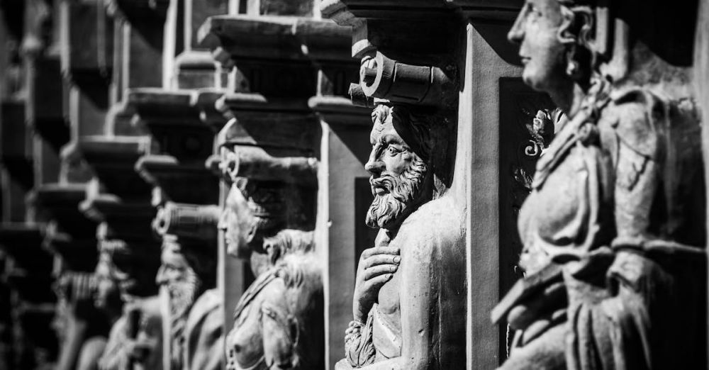 History - Black and white photo of historic stone sculptures showcasing intricate craftsmanship.