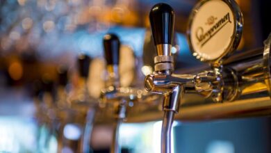 Pub - Focused image of a shiny beer tap in a stylish bar with a blurred background.