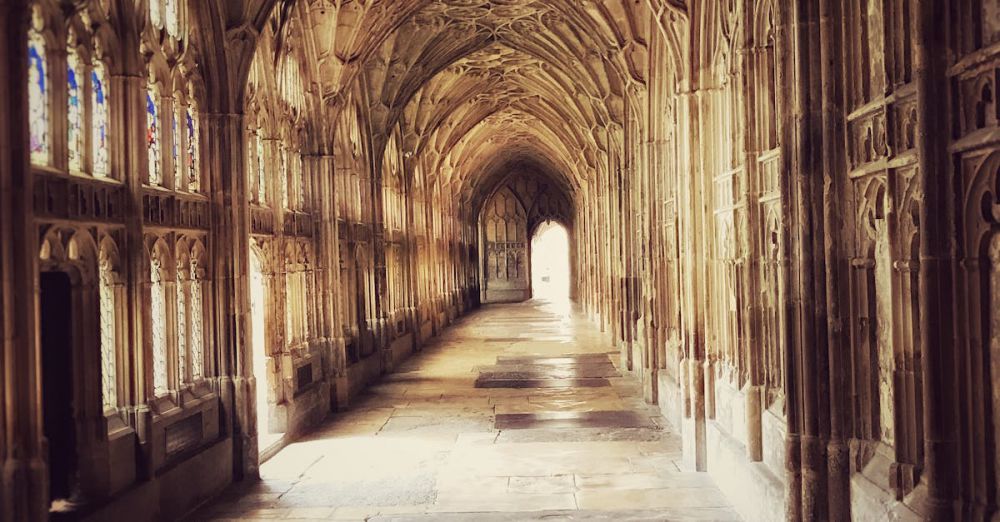 Historical - Explore the detailed Gothic architecture of the historic cloister at Gloucester Cathedral, England.