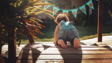 Crawl - Adorable toddler exploring a sunlit garden, showcasing childhood curiosity and fun during summer.