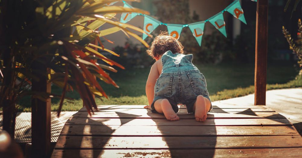 Crawl - Adorable toddler exploring a sunlit garden, showcasing childhood curiosity and fun during summer.