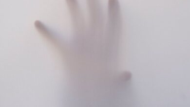 Ghosts - Eerie image of a hand reaching through a foggy surface, evoking mystery and suspense.