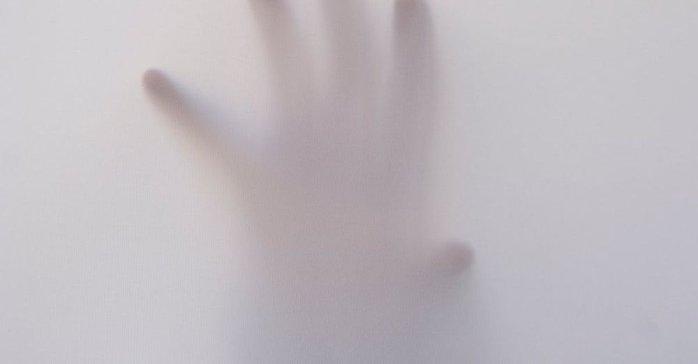 Ghosts - Eerie image of a hand reaching through a foggy surface, evoking mystery and suspense.