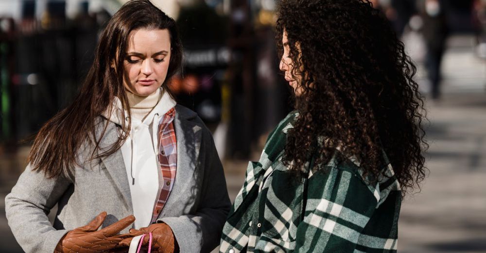 Outdoor Gifts - Women wearing gloves and outerwear standing with paper packages and handbags after shopping in city