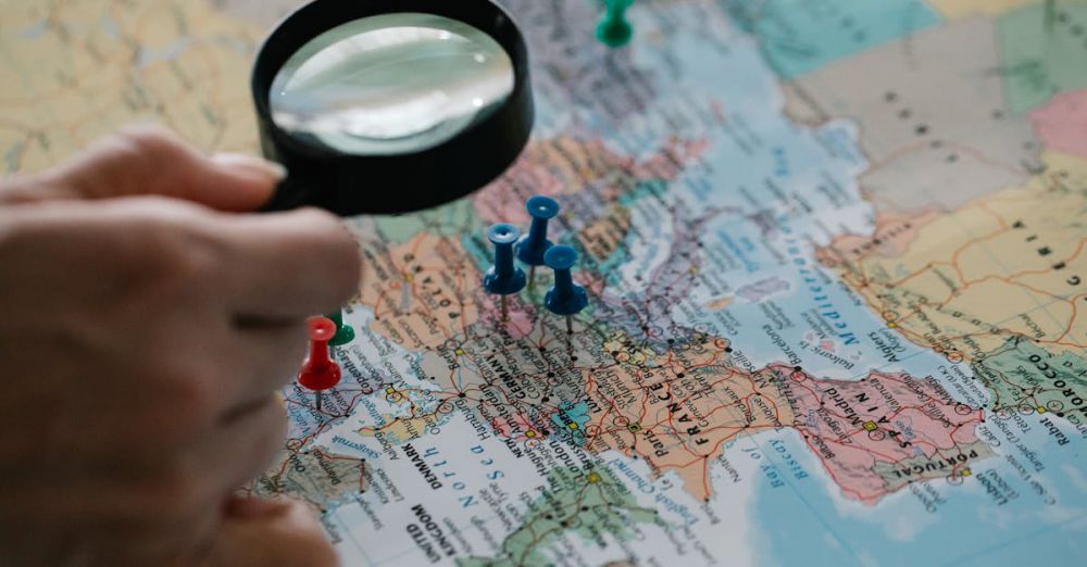 Locations - Magnifying glass focuses on pins highlighting travel destinations on a world map.