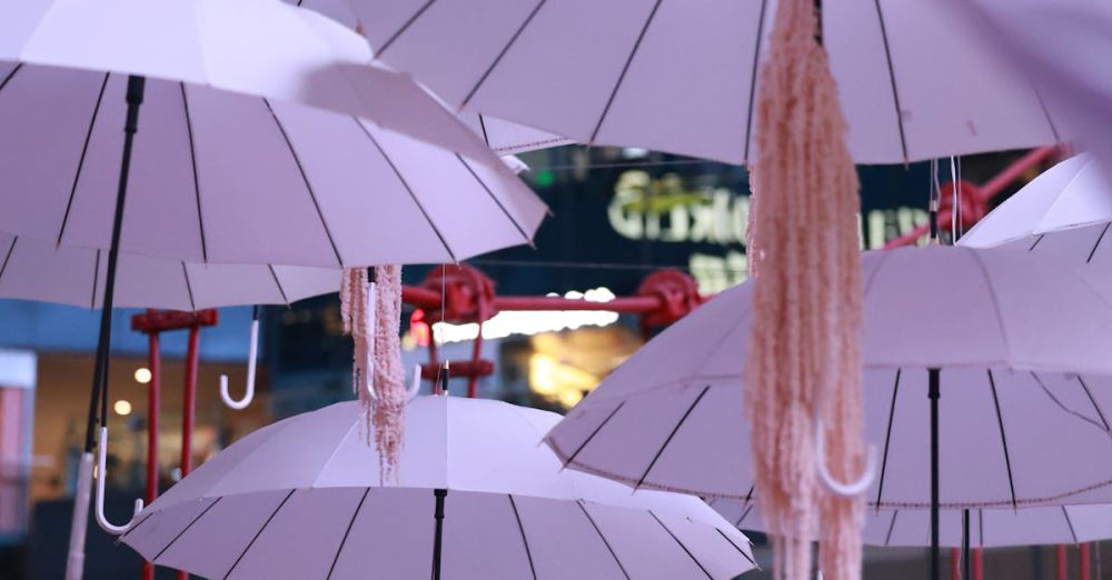 Areas - Creative installation of umbrellas hanging indoors in a vibrant mall setting.