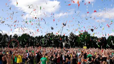 Festivals - A lively crowd enjoying a colorful juggling event outdoors. Perfect for summer festival themes.