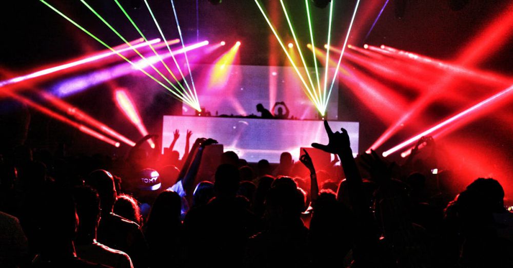 Club - Energetic nightclub scene with laser lights and a lively crowd dancing to EDM music.