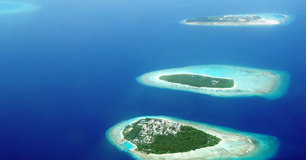 Islands - Stunning aerial shot of tropical Maldives islands surrounded by the turquoise sea.