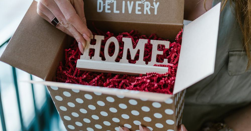 Personalized Gifts - A woman opening a polka dot box labeled 'Special Delivery' with 'HOME' inside.