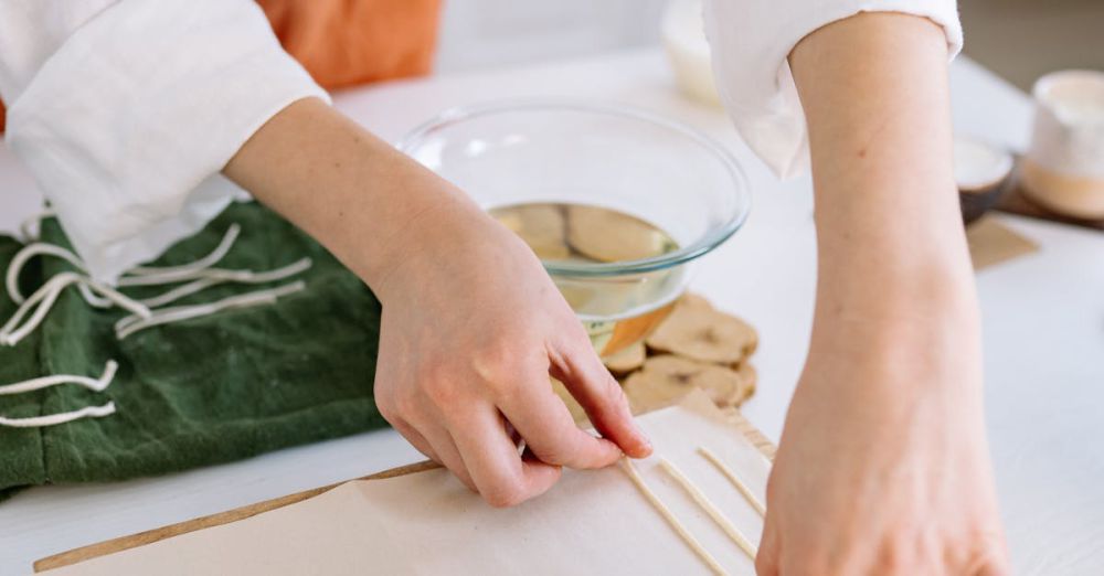 Craft Kits - A person crafting handmade candles with natural materials on a table.