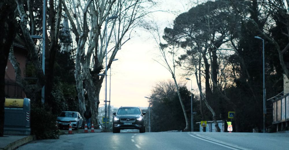 Parkway - A peaceful, empty urban street at twilight, lined with trees and parked cars, capturing a serene city atmosphere.