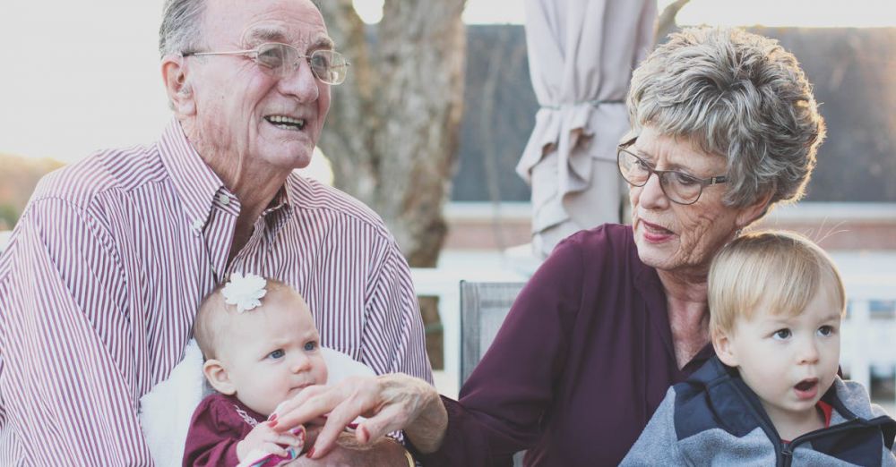 Family - Grandparents spending joyful moments with their grandchildren in an outdoor setting, captured candidly.