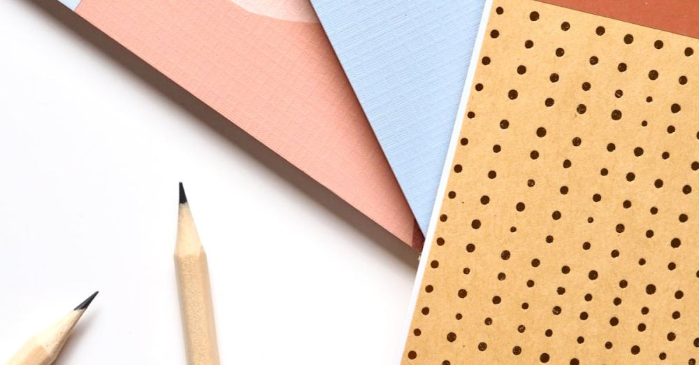 Stationery - Colorful notebooks and pencils arranged neatly for a creative workspace.