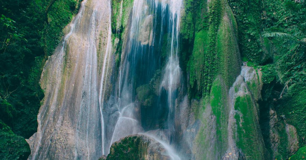 Waterfalls - Stunning waterfall cascading over mossy rocks in Bato, Bicol's vibrant jungle setting.