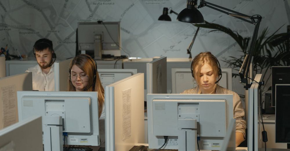 Operators - Call center agents working diligently with computers and headphones, providing customer support.