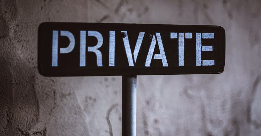 Private - A weathered 'Private' sign on a rustic wall background in Solvang, California.