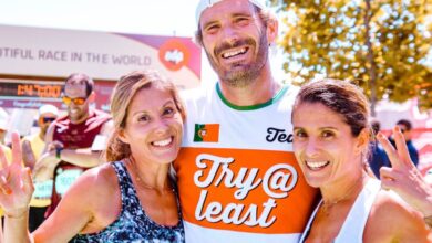 Races - Three runners proudly celebrate finishing a marathon together with smiles and peace signs.