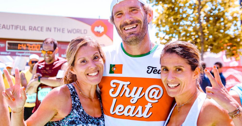 Races - Three runners proudly celebrate finishing a marathon together with smiles and peace signs.