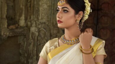 Traditional - Beautiful Indian woman in traditional saree, adorned with exquisite jewelry, set against historic architecture.