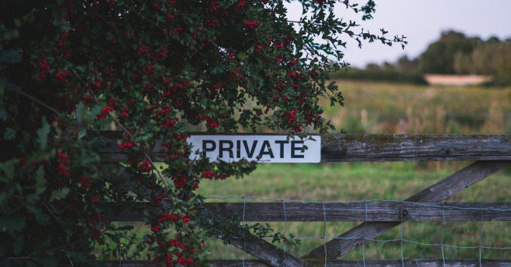 Private - Wooden fence with private sign and red berries in a rural garden landscape