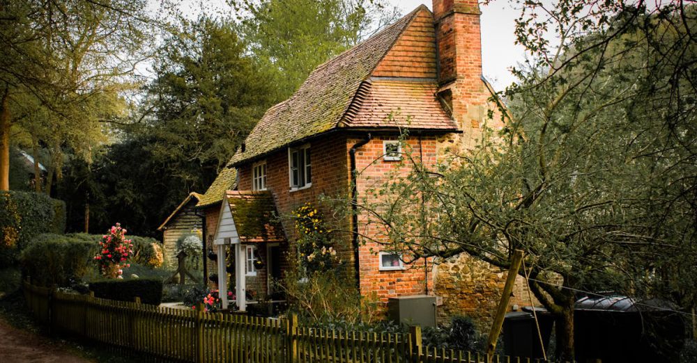 Cottage - Picturesque brick cottage nestled in a lush garden setting, showcasing rustic charm and tranquility.