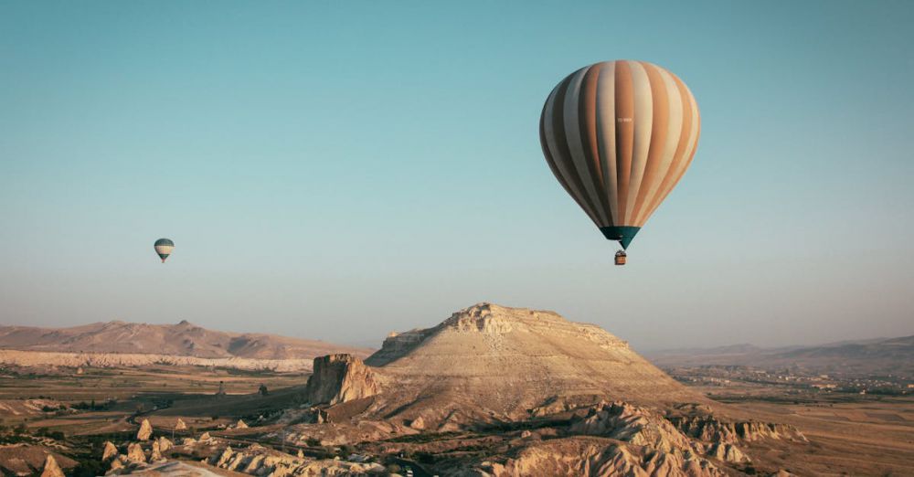 Nature - Hot air balloons float over the mesmerizing landscape of Cappadocia, Turkey at sunrise.