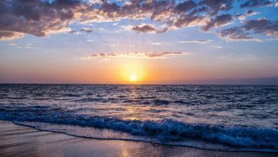 Beaches - Captivating sunset over the ocean with vibrant colors, serene waves, and a peaceful sky.