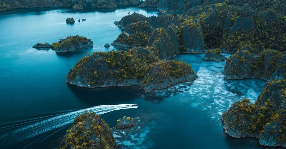 Islands - Stunning aerial view of Raja Ampat's blue waters and unique rock formations in West Papua, Indonesia.