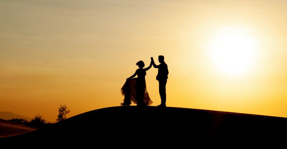 Sunset - Silhouetted couple dancing on the beach during a golden sunset, creating a romantic scene.