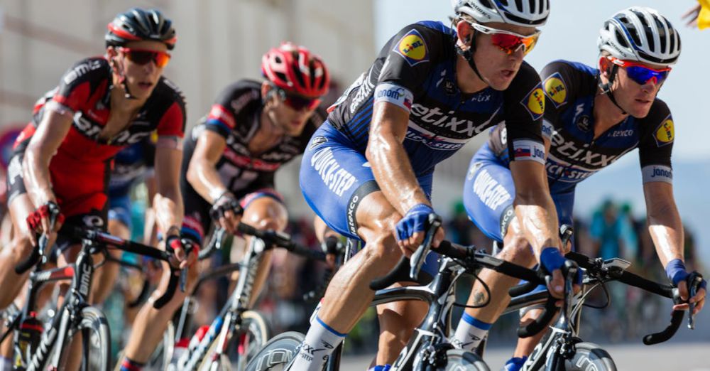 Cycling - Competitive cyclists in a high-speed race, showcasing athleticism and teamwork.