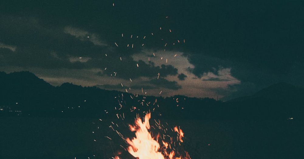 Bonfire - A peaceful campfire burning brightly under a starry sky in Colibița, Romania, creating a warm and cozy atmosphere.