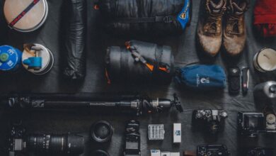 Equipment - Flat lay of outdoor camping and photography equipment neatly organized.