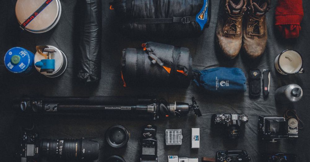 Equipment - Flat lay of outdoor camping and photography equipment neatly organized.