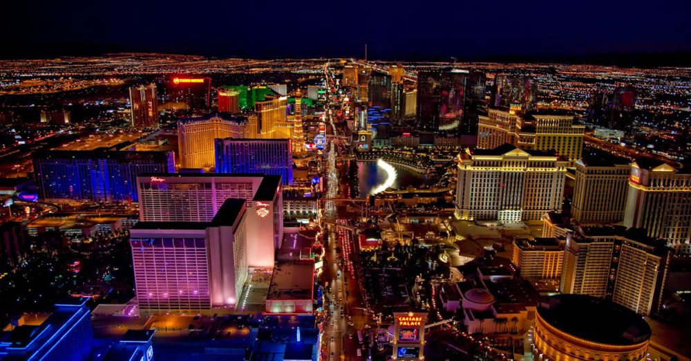 Luxury Hotels - Stunning aerial view of Las Vegas Strip glowing at night with vibrant neon lights and bustling nightlife.