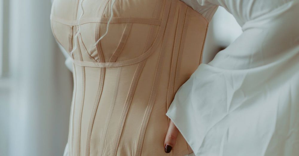 Luxury Clothing - Close-up of a woman in a historical white dress with a corset indoors, evoking vintage elegance.