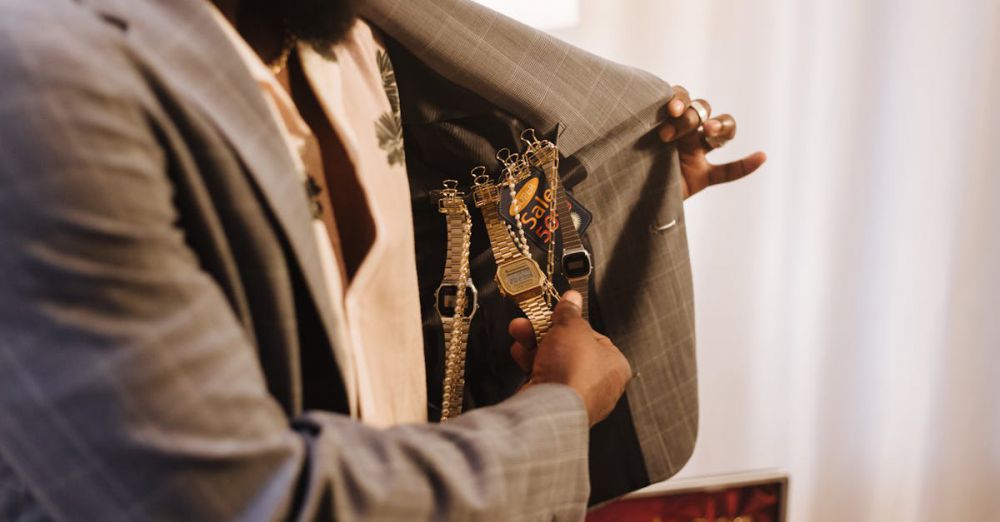 Luxury Watches - A man reveals multiple watches inside his suit jacket, showcasing a variety of styles.