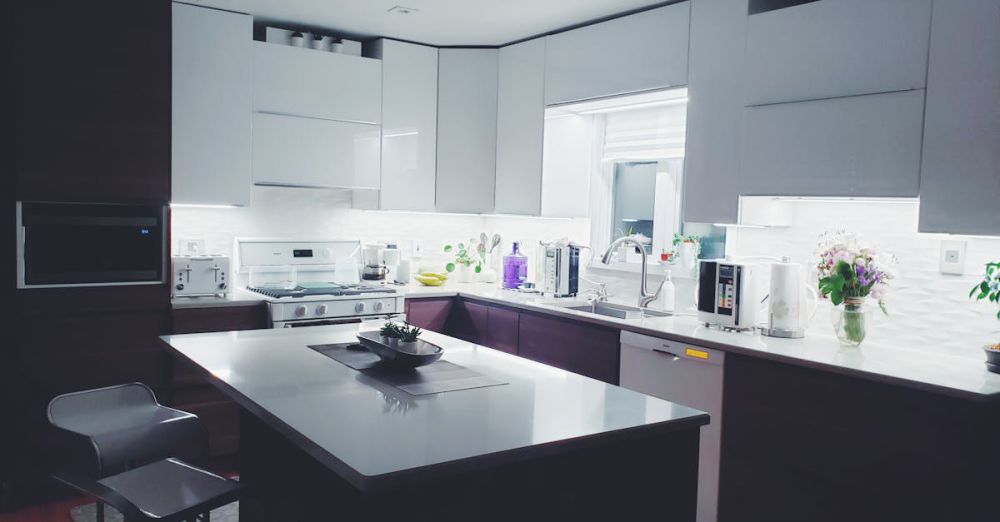 Home Appliances - Contemporary kitchen interior with sleek white cabinets and island, perfect for a minimalist aesthetic.