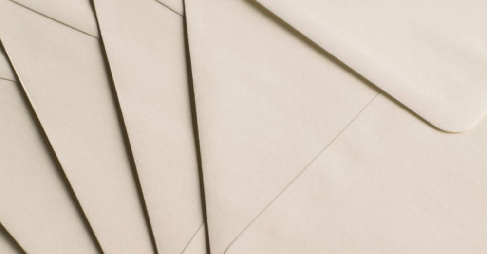 Envelopes - A close-up photo of beige envelopes arranged on a neutral background, ideal for stationery themes.