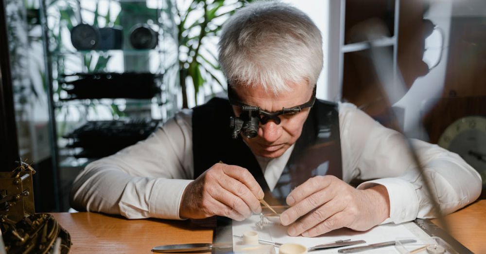 Luxury Watches - Senior watchmaker focuses intently on intricate repair work using specialized tools in a workshop.