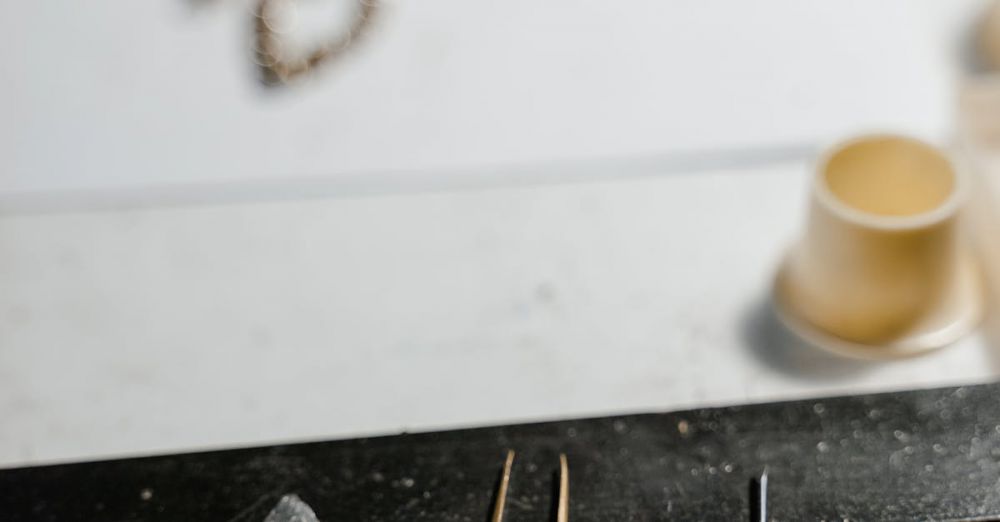 Luxury Watches - Close-up of watch repair tools and jewelry on a workbench, showcasing craftmanship.