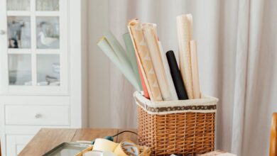 Wrapping Papers - Stylish gift wrapping scene with ribbons and baskets on a wooden table indoors.