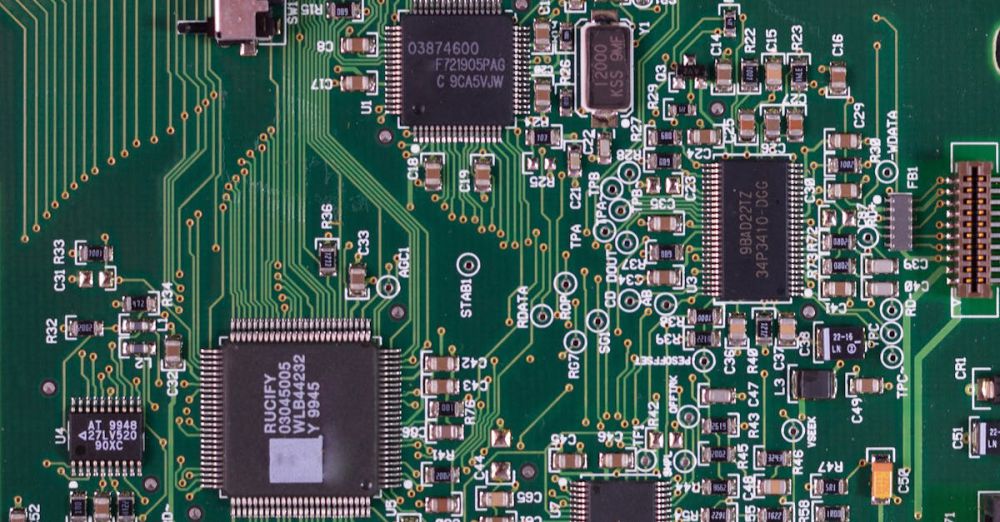 Electronics - Detailed image of a green circuit board featuring various components and microprocessors.