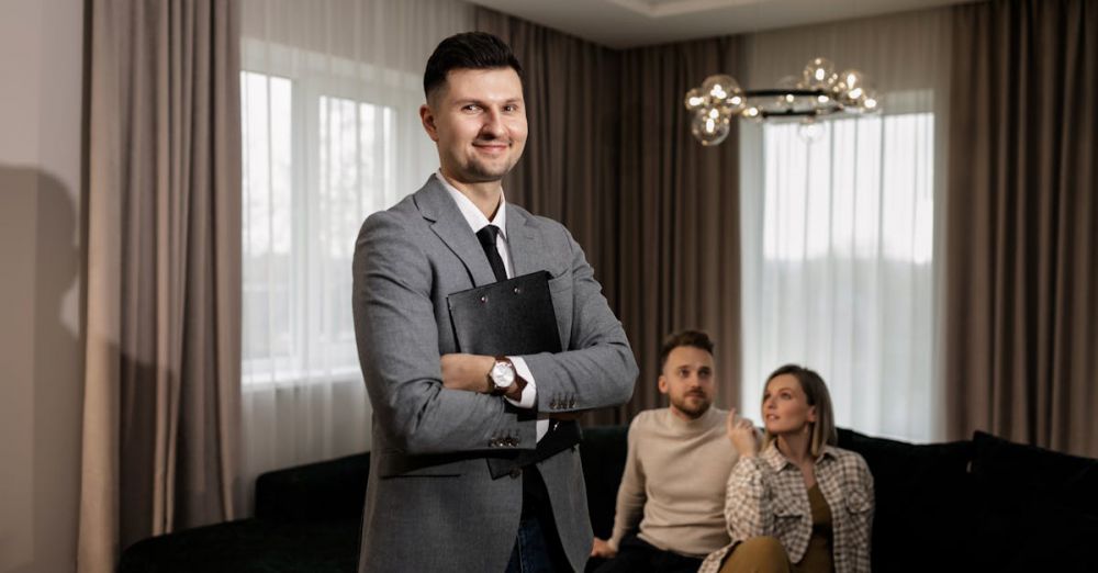 Deals - Smiling real estate agent with a clipboard indoors, showing a property to a couple.