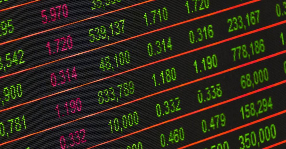 Markets - Close-up of a digital stock market data display showing colorful financial numbers and trends.