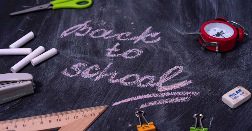 School Supplies - An arrangement of school supplies with 'back to school' written on a chalkboard.