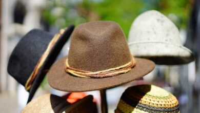 Hats - A vibrant display of fashionable fedoras stacked outdoors. Perfect for sun protection and style.