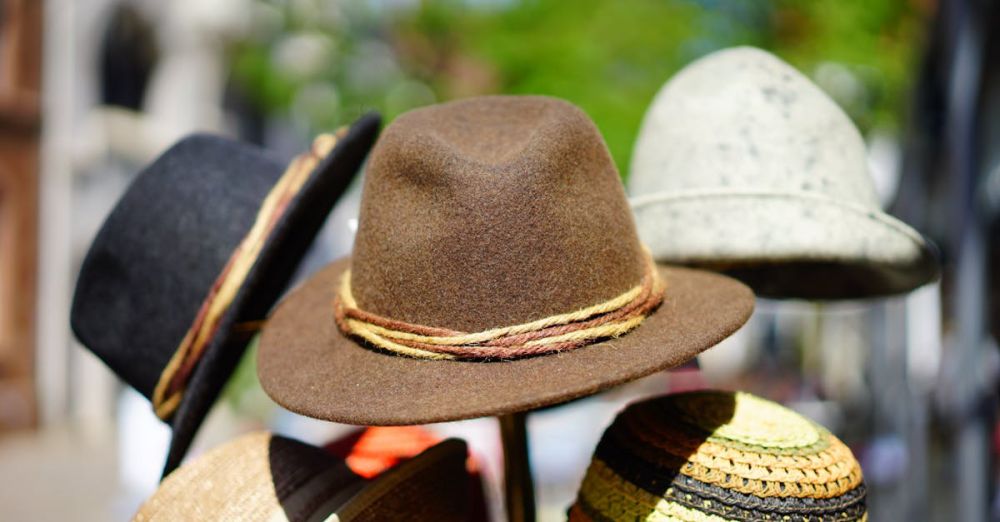 Hats - A vibrant display of fashionable fedoras stacked outdoors. Perfect for sun protection and style.