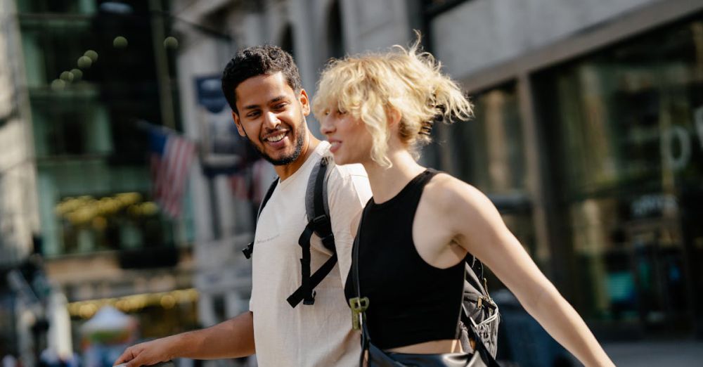 Travel Bags - A man and a woman joyfully strolling through urban streets, capturing city life excitement.